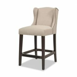 Hot Sale ๐คฉ Suzie 39.75 in. Desert Beige Shelter Wingback Rubber Wood 27 in. Counter-Height Barstool with Polyester Seat by Jennifer Taylor ๐